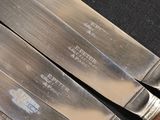 three knives that are sitting next to each other on a table