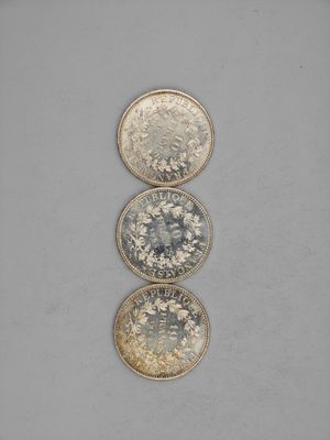 three different types of coins sitting on top of each other