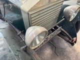 a old car that is parked on the side of the street