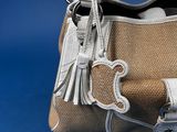 a purse that is sitting on a blue surface