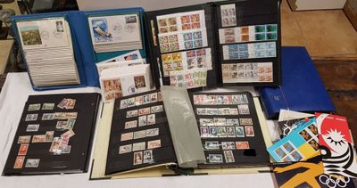a lot of stamps on a table with a binder