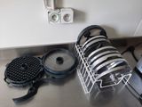 many plates and pans sitting on the kitchen counter