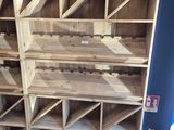 un grand casier à vin en bois sur lequel sont disposées de nombreuses bouteilles