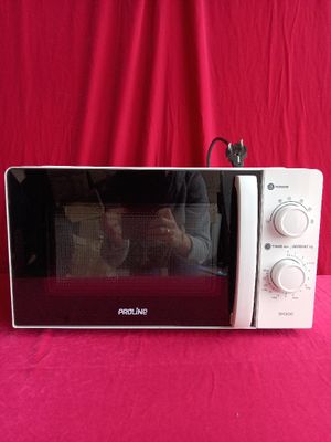 someone is taking a picture of their reflection in the microwave