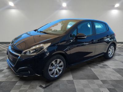 a black car parked in a garage with a checkered floor