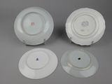 three white plates sitting on top of a table next to each other