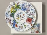 an image of a plate with a painting on it sitting on top of a box