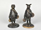 paire de figurines en bronze représentant un garçon et une fille avec un sac