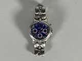a silver watch with a blue face on a white surface