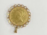 a close up of a gold coin on a white surface