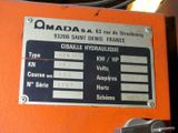 a sign on the side of an orange machine