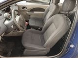 the interior of a car with the door open and the driver ' s seat down
