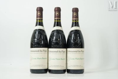 three bottles of wine are lined up on a white surface