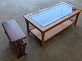 a table with a glass top next to a bench