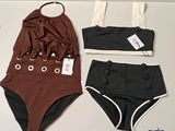 two pieces of swimsuits are sitting on a table next to a pair of underwear