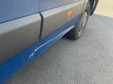 a close up of a blue van parked on the street