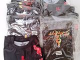 many t - shirts wrapped in plastic bags on a table