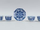 a group of blue and white dishes and cups