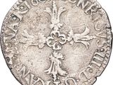 an old silver coin with a cross on it