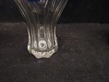a glass vase with a blue and white flower inside of it