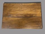 an old wooden cutting board sitting on top of a gray surface