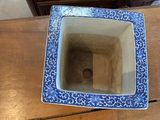 a blue and white bowl sitting on a wooden table