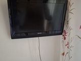 a flat screen tv mounted on the wall in the corner of the room