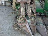 a tractor that is parked next to a pile of dirt