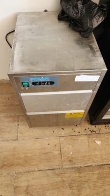an image of a kitchen with a stove and a trash can
