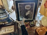a picture of an owl sitting on a table next to a lamp