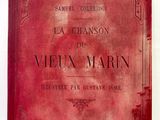 un vieux livre à la couverture rouge posé sur un mur blanc