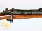 a close up of a rifle on display on a white surface