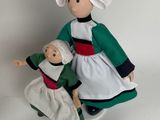 dolls are dressed in traditional clothing and are standing next to each other