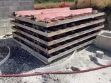 a pile of wood sitting on top of a pile of concrete