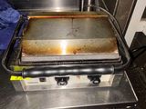 a grill with a pan on top of it in a kitchen