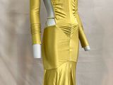 the mannequin is wearing a yellow dress with long sleeves