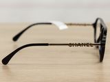 the glasses are black and gold on a wooden table