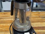 a coffee maker sitting on top of a wooden table