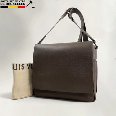a brown leather handbag next to a canvas bag with a logo on it