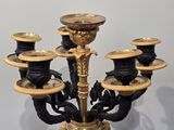 a black and gold candelab with five candles