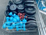 a shopping cart full of tires and other items in the parking lot