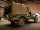 a military vehicle parked in a building with a tarp on top of it