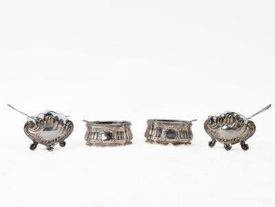 three pieces of silverware sitting on top of a white surface