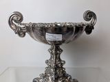 silver plated bowl on clear glass table with white background