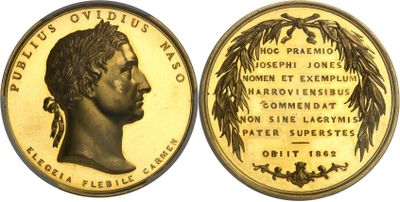a close up of a gold coin with a woman ' s face