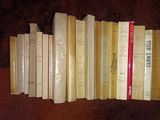 several books are stacked on top of each other on a table