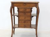 a small wooden table with a drawer on top of it