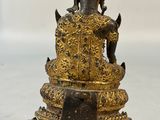 bronze statue of a seated buddha on a pedestal with a white background