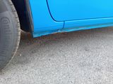 a blue car that is parked on the side of the road