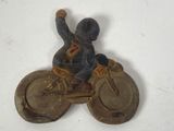 a figurine of a man riding a motorcycle